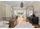 Beautiful foyer with hardwood floors, wrought iron staircase, and views into the living room at 10915 Hermit Thrush Ln, Charlotte, NC 28278