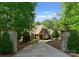 Beautiful home showcases a stone entrance and a long driveway framed by mature trees at 10915 Hermit Thrush Ln, Charlotte, NC 28278