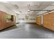 Spacious three-car garage with epoxy flooring, cabinets, pegboard, and ample storage at 10915 Hermit Thrush Ln, Charlotte, NC 28278