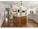 Gourmet kitchen features a central island, custom cabinets, and stainless steel appliances at 10915 Hermit Thrush Ln, Charlotte, NC 28278