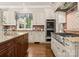 Spacious kitchen showcasing high-end appliances and custom cabinetry at 10915 Hermit Thrush Ln, Charlotte, NC 28278