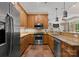 Well-equipped kitchen with stainless steel appliances, granite countertops, and tile flooring at 10915 Hermit Thrush Ln, Charlotte, NC 28278