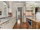 Kitchen featuring granite countertops, custom cabinets, and updated appliances at 10915 Hermit Thrush Ln, Charlotte, NC 28278