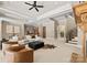 Expansive living room with fireplace, staircase, bar, and ample seating at 10915 Hermit Thrush Ln, Charlotte, NC 28278