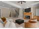 Spacious living room featuring a fireplace, staircase, and comfortable seating arrangement at 10915 Hermit Thrush Ln, Charlotte, NC 28278