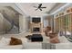 The living room features a fireplace, staircase, and a glass door leading to the outside at 10915 Hermit Thrush Ln, Charlotte, NC 28278