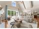 Elegant living room with high ceilings, fireplace, and access to the outdoor patio at 10915 Hermit Thrush Ln, Charlotte, NC 28278