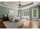 Large main bedroom with tray ceiling, hardwood floors, and ample natural light at 10915 Hermit Thrush Ln, Charlotte, NC 28278