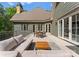 An outdoor patio featuring a seating area, dining table, and gray rug at 10915 Hermit Thrush Ln, Charlotte, NC 28278