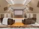 Home theater with tiered seating, projector screen, and cozy leather recliners for entertainment at 10915 Hermit Thrush Ln, Charlotte, NC 28278