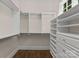 Bright walk-in closet with custom shelving and drawers, offering ample storage space and organization at 10915 Hermit Thrush Ln, Charlotte, NC 28278