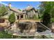 Exterior of home featuring gorgeous stone waterfall and meticulous landscaping at 10915 Hermit Thrush Ln, Charlotte, NC 28278