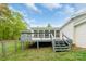 The back deck features access to a screened-in porch, and stairs lead down to the yard at 1106 University Dr, Lancaster, SC 29720