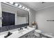 Bathroom featuring a large mirror, modern vanity with black hardware, and tub with shower at 1106 University Dr, Lancaster, SC 29720