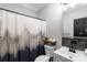 Modern bathroom features updated vanity, a decorative shower curtain, and a decorative shelf for a fresh and stylish look at 1106 University Dr, Lancaster, SC 29720