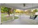 Welcoming covered front porch with a swing, showcasing a peaceful outdoor area and attractive curb appeal at 1106 University Dr, Lancaster, SC 29720