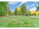 Large, well-manicured front yard with lush green grass and mature trees at 1106 University Dr, Lancaster, SC 29720