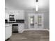 Bright and airy kitchen with stainless steel dishwasher and glass paneled doors at 1106 University Dr, Lancaster, SC 29720