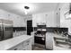 Bright kitchen with white cabinets and black backsplash at 1106 University Dr, Lancaster, SC 29720
