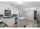 Bright kitchen with white cabinets, stainless steel appliances and dining area at 1106 University Dr, Lancaster, SC 29720