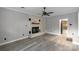 Cozy living room featuring a charming white brick fireplace and laminate floors, perfect for a relaxing ambiance at 1106 University Dr, Lancaster, SC 29720