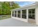 Enclosed back porch with screened windows offering great views of the surrounding yard at 1106 University Dr, Lancaster, SC 29720