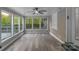 Bright sunroom with large windows offering serene views and a ceiling fan at 1106 University Dr, Lancaster, SC 29720