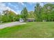 Vast lawn with mature trees, offering a serene and private outdoor setting for this charming home at 1106 University Dr, Lancaster, SC 29720