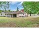 View of a backyard with a covered patio, detached garage, and grassy yard at 1116 Montgomery Ave, Albemarle, NC 28001