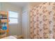 Bathroom featuring shower with leaf-patterned curtain and a window providing natural light at 1116 Montgomery Ave, Albemarle, NC 28001