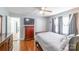Bedroom with hardwood floors, ceiling fan, dresser, closet, and an open door at 1116 Montgomery Ave, Albemarle, NC 28001
