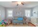 Bedroom with crib, a ceiling fan, and two windows, providing plenty of natural light at 1116 Montgomery Ave, Albemarle, NC 28001