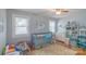 Bedroom featuring a crib and two windows, with shelving, and natural light at 1116 Montgomery Ave, Albemarle, NC 28001