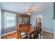 Traditional dining room with wood paneled accent wall, hardwood floors, large china cabinet, and view of kitchen at 1116 Montgomery Ave, Albemarle, NC 28001