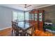 Elegant dining room with a large wooden table, ornate hutch, and bright, natural light at 1116 Montgomery Ave, Albemarle, NC 28001