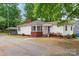 Charming single-story home featuring a welcoming front porch, brick accents, and a well-maintained lawn at 1116 Montgomery Ave, Albemarle, NC 28001