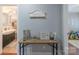 Hallway with a view of a bathroom and a playroom, featuring a wooden table and decorative items at 1116 Montgomery Ave, Albemarle, NC 28001