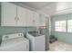 Functional laundry room with a washer, dryer, and storage cabinets at 1116 Montgomery Ave, Albemarle, NC 28001