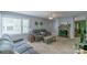 Comfortable living room with a fireplace, neutral-toned furniture, and a ceiling fan at 1116 Montgomery Ave, Albemarle, NC 28001