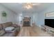 Open-concept living room featuring a brick fireplace, ceiling fan, and views into other rooms at 1116 Montgomery Ave, Albemarle, NC 28001
