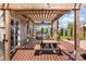 Inviting backyard deck with a pergola, outdoor seating, and a view of the beautifully landscaped yard at 1124 Culver Spring Way, Charlotte, NC 28215
