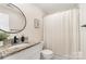Bathroom boasts granite counters, a modern black faucet, and a shower with decorative curtain at 1124 Culver Spring Way, Charlotte, NC 28215