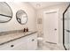 Bathroom featuring double sinks with granite counters, white cabinets and a glass shower at 1124 Culver Spring Way, Charlotte, NC 28215