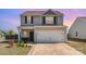Charming two-story home featuring a two-car garage, neutral siding, and well-maintained landscaping at 1124 Culver Spring Way, Charlotte, NC 28215
