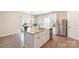 Modern kitchen with a large island, stainless steel appliances, and open layout to the dining area at 1124 Culver Spring Way, Charlotte, NC 28215