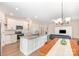 Open-concept kitchen featuring granite counters, stainless appliances, white cabinets, and seamless flow to the living area at 1124 Culver Spring Way, Charlotte, NC 28215