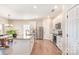 Bright kitchen with white cabinets, granite countertops, stainless steel appliances, and a center island at 1124 Culver Spring Way, Charlotte, NC 28215