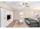 Bright living room with built-in storage, ceiling fan, and sliding glass doors to the backyard at 1124 Culver Spring Way, Charlotte, NC 28215