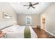Spacious main bedroom featuring a ceiling fan, wainscotting, and ensuite bathroom access at 1124 Culver Spring Way, Charlotte, NC 28215