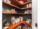 Spacious pantry with dark painted walls and natural wood shelving, offering ample storage for food and supplies at 1124 Culver Spring Way, Charlotte, NC 28215